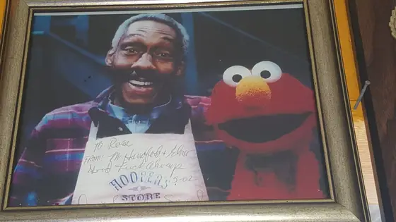 A framed, signed photo of a guest with Elmo