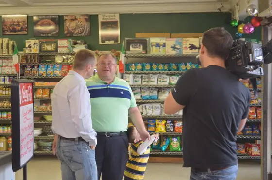 A TV crew filming in the deli aisle