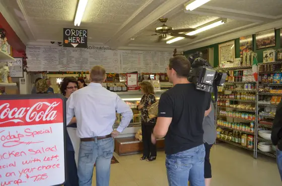 A TV crew filming at the deli counter