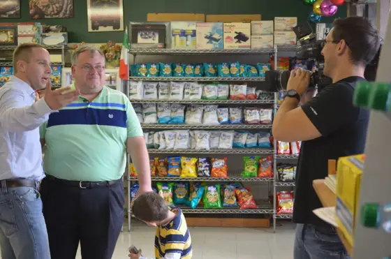 A TV crew interviewing Jerry inside the deli